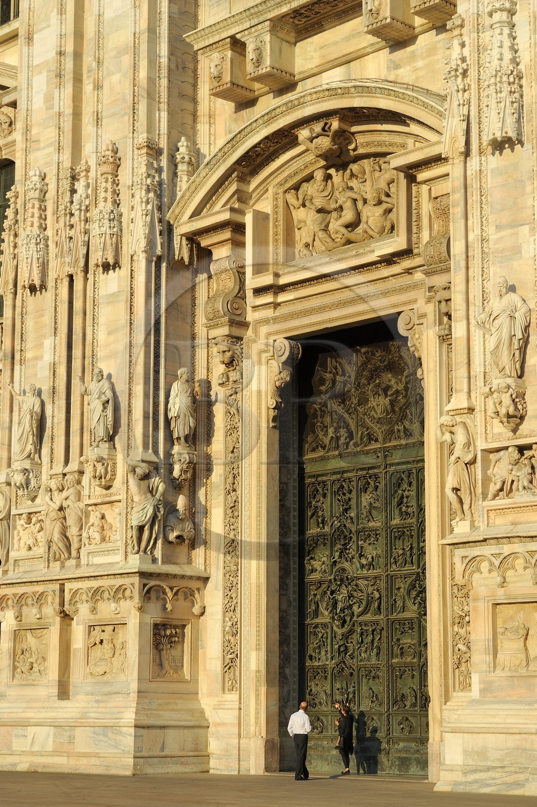 Italy, Lombardy, Milan, the Duomo in the historical center, cathedral in Gothic Flamboyant style, central portal surmounted by a tympanum representing the Creation of Eve (drawings by Cerano)