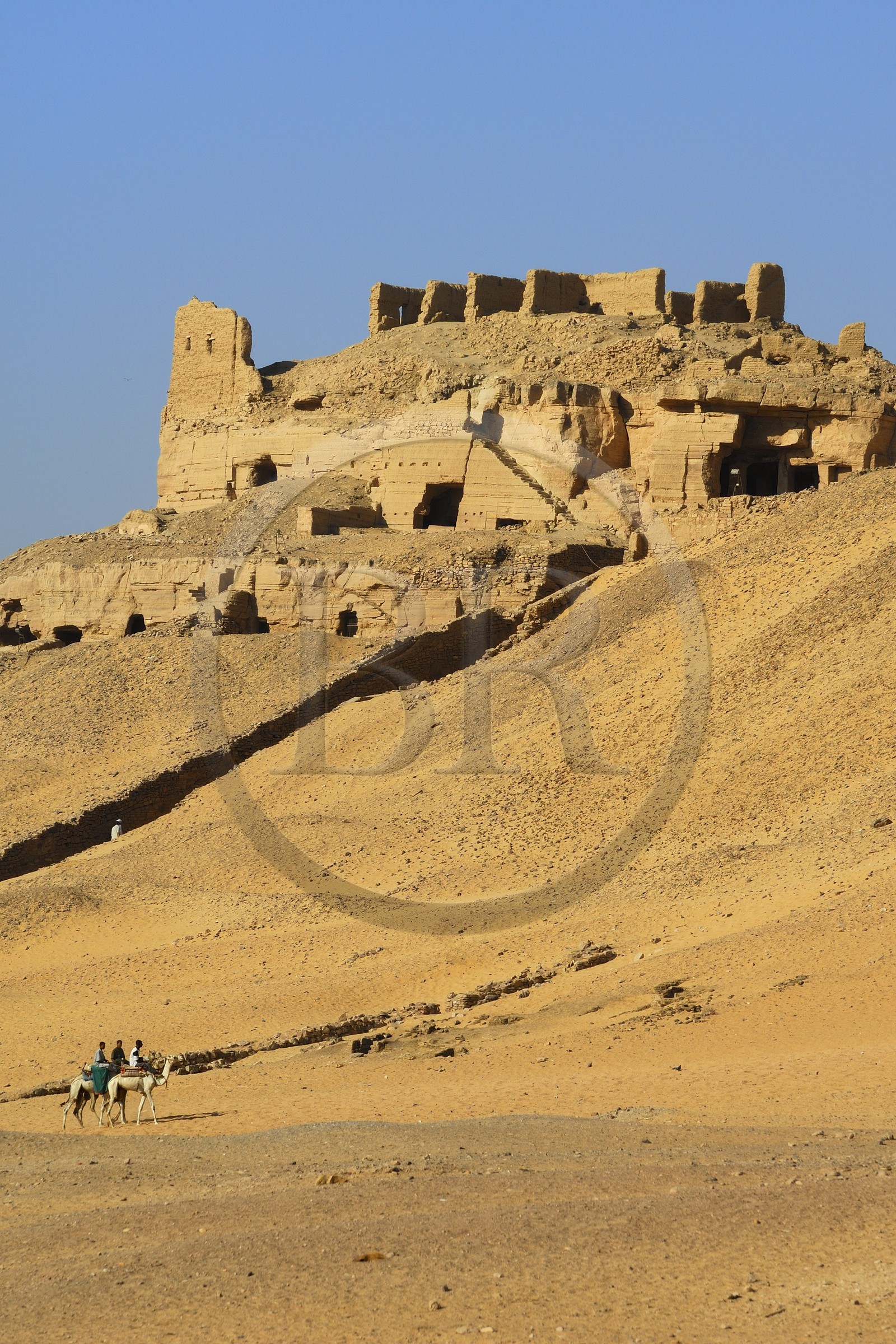 Egypt, Upper Egypt, Nubia, Nile Valley, Aswan, the tombs of ancient Nobles on the western bank and riders riding their dromedaries