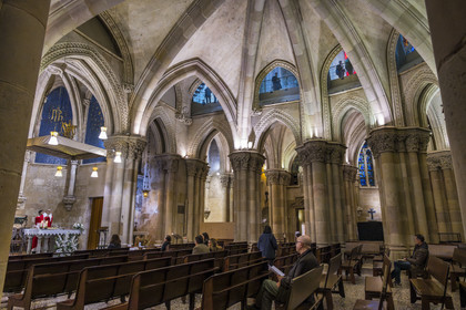 Spain, Catalonia, Barcelona, Eixample district, Sagrada Familia basilica by Catalan modernist architect Antoni Gaudi, listed as a UNESCO World Heritage Site, the neo-Gothic style temple crypt serves as a parish church, priest Joby Sebastian Kappiparambil celebrates mass