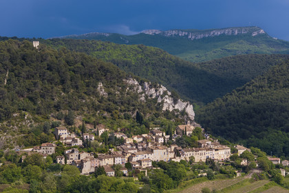 France, Vaucluse, Dentelles de Montmirail mountains, the medieval village of Séguret, labelled Les Plus Beaux Villages de France (The Most Beautiful Villages of France), on a stormy day and the Saint-Amand ridge seen from the south in the background (aerial view)