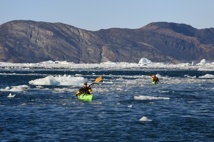 Greenland, west coast, Disko Bay, Quervain Bay, kayaks progressing among icebergs