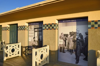 France, Calvados, Pays d'Auge, Deauville, the famous planks on the beach, lined with Art Deco style bathing cabins, tribute to Cartier-Bresson and Doisneau