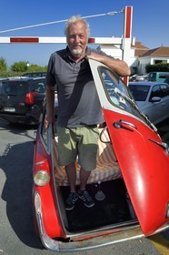 France, Pyrenees Atlantiques, Basque Country coast, Guethary, French journalist, writer and director Alain Gardinier driving his BMW Isetta