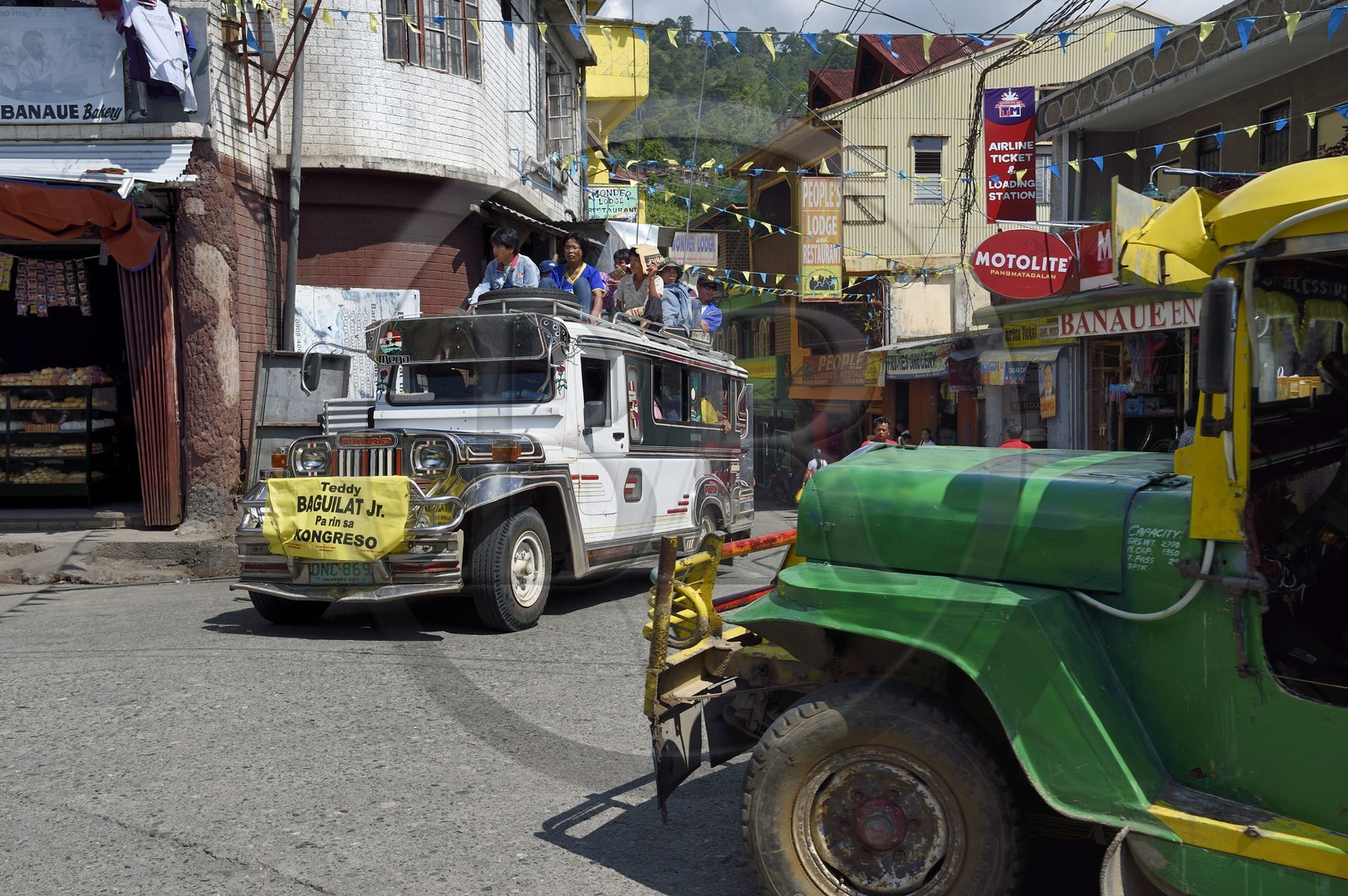 Philippines, Ifugao province, Banaue town, jeepney (elongated jeep to transport passengers) on the main square, passengers on the roof