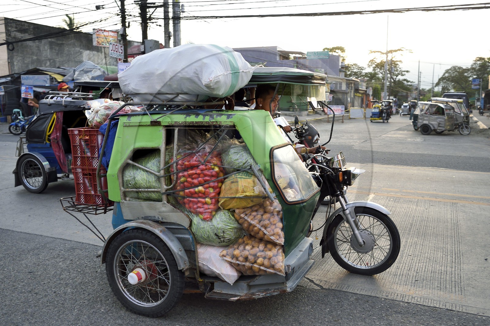 Philippines, province of Nueva Ecija, Bambang, freight transport in motorized tricycle in main street