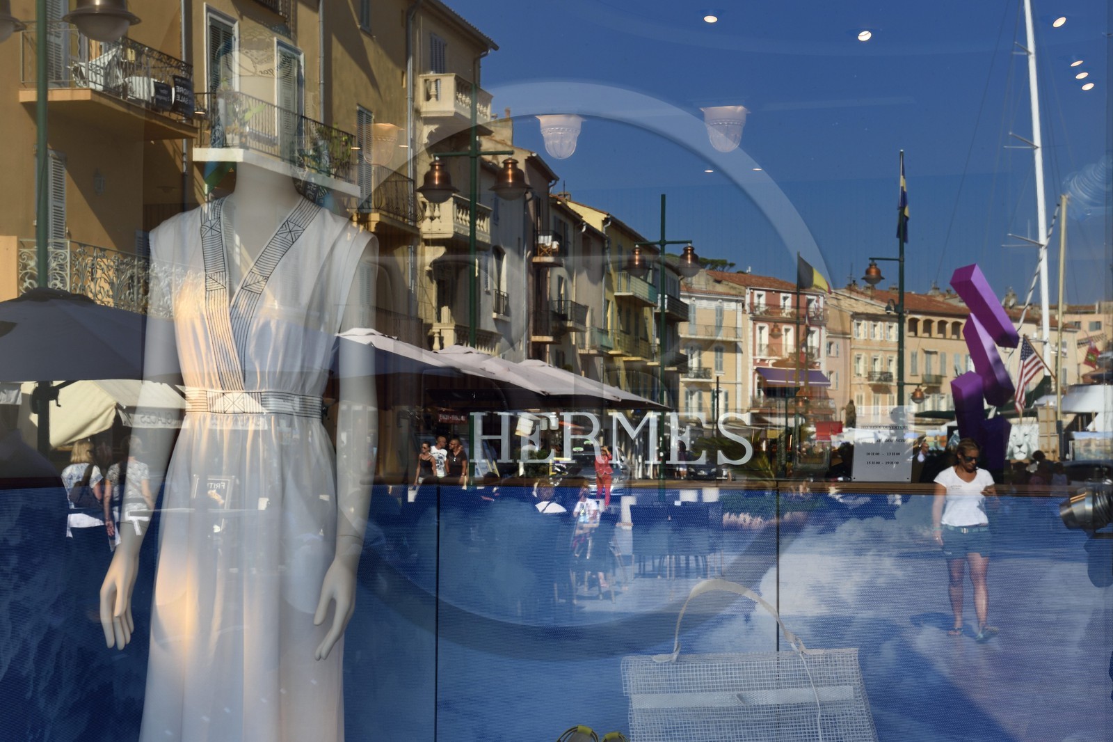 France, Var, Saint-Tropez, reflection of the port houses in the window of the Hermes shop