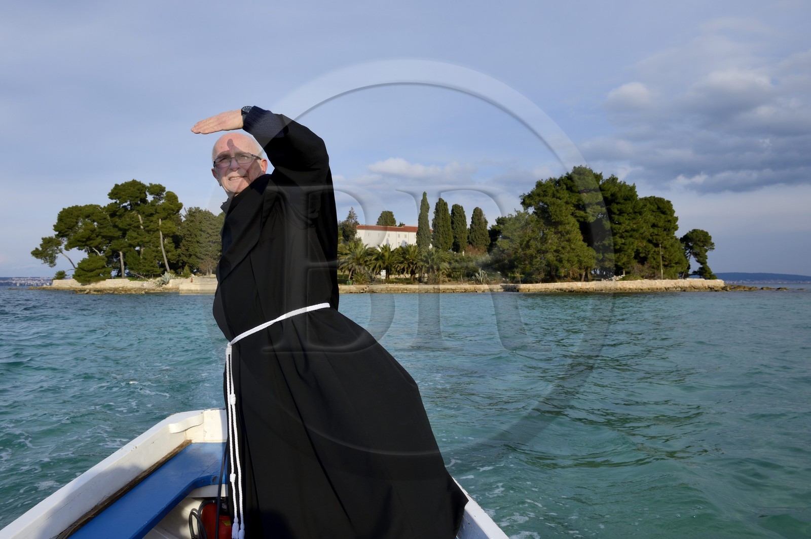 Croatia, Dalmatia, Dalmatian Coast, Ugljan Island, Preko, Franciscan friar Bozo Susic leaving the Franciscan Monastery of the Galovac island on his boat